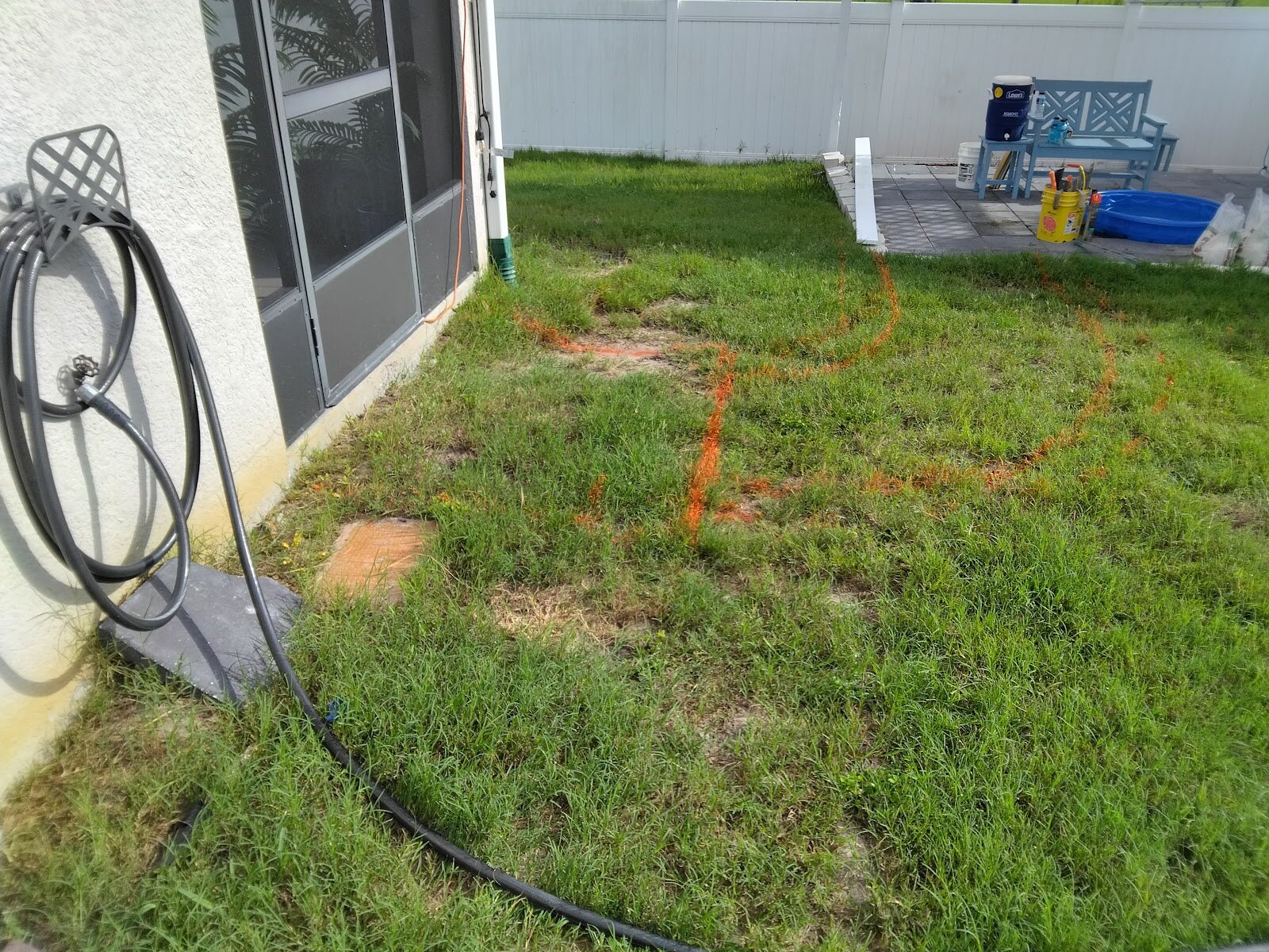 Before: bare marked-out yard before the paver patio was installed