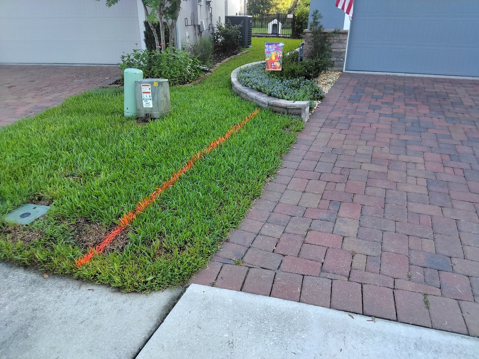 Finished red brick paver driveway with fresh landscaping, an Expert Stone & Brick Pavers project in DeLand