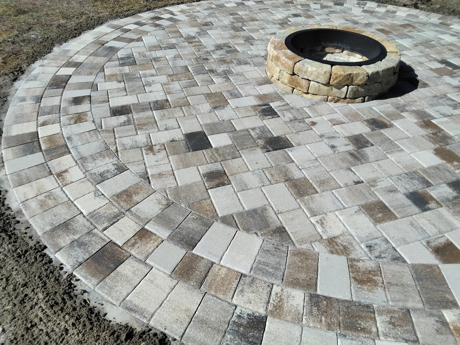 Circular paver patio with a stone fire pit, Expert Stone & Brick Pavers