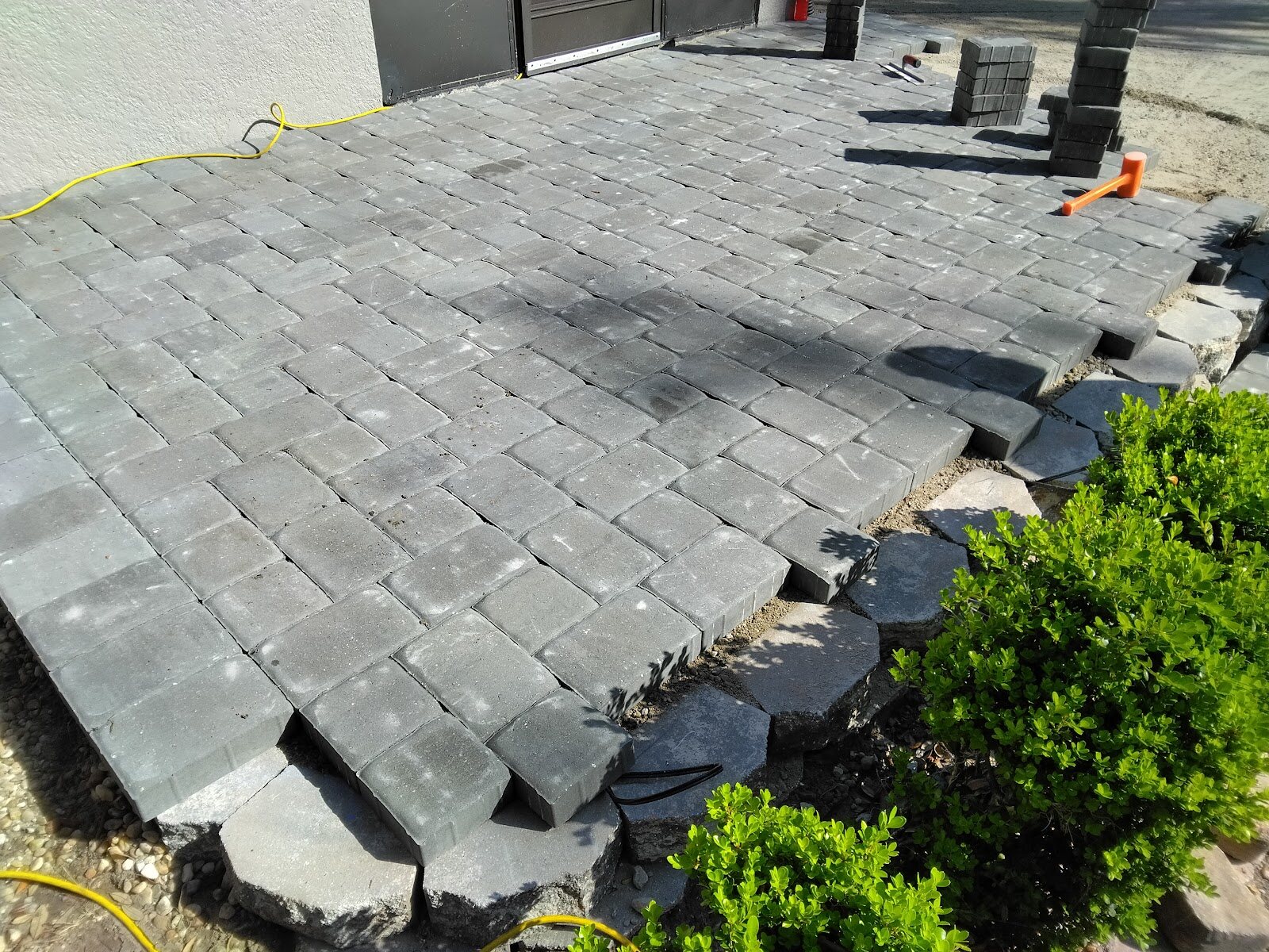 Charcoal cobblestone paver patio with a stone border, Expert Stone & Brick Pavers